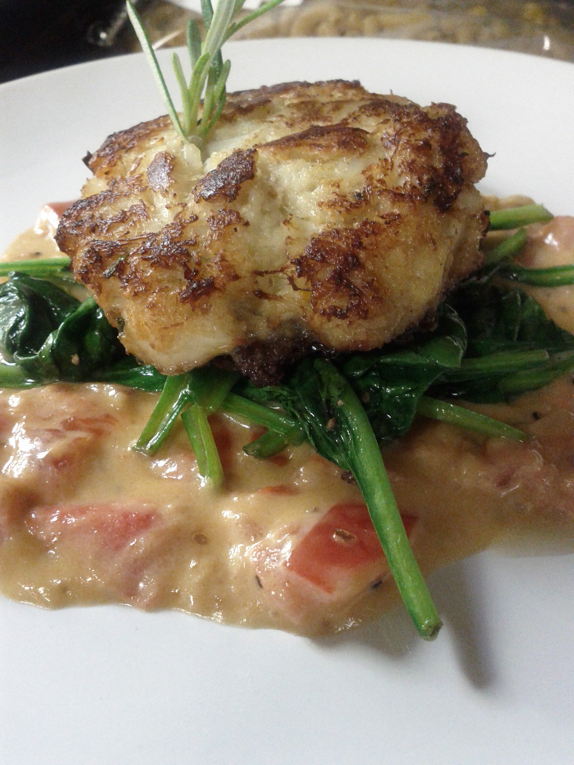 Pan seared crab cake with garlic wilted spinach and tomato / white wine pan sauce