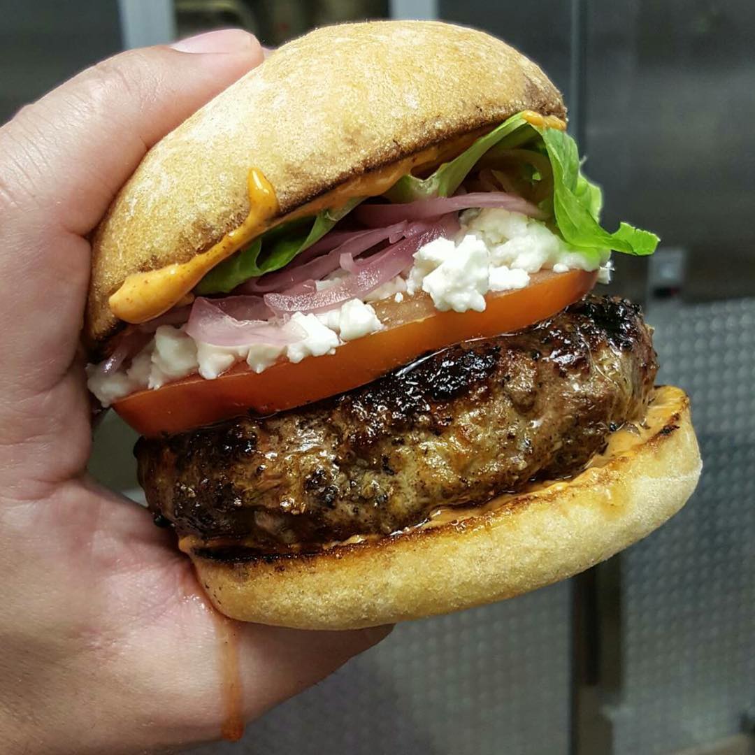 @chefmarcmarrone getting in ready for Greatness!! This amazing looking 🍔 is filled with goat feta, pickled red onion, harrisa aioli and tomato!!